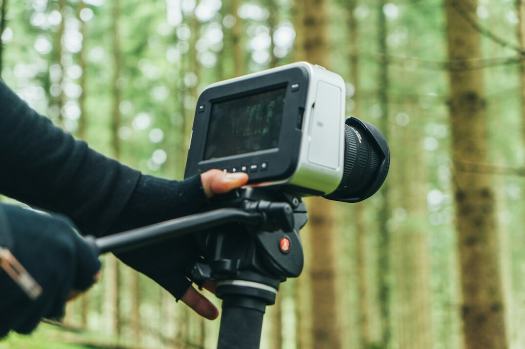 Camera operator filming a live outdoor broadcast